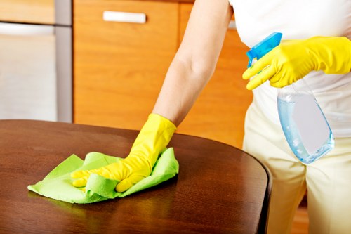 Carpet cleaning equipment and technician working in a Canary Wharf interior